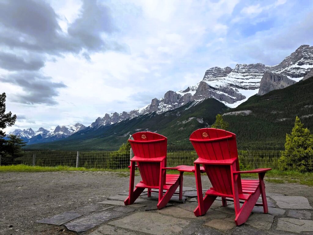 three sisters mountains and banff red chairs